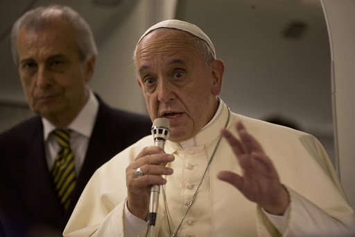 IN FLIGHT : Pope Francis talks to journalists during a press conference