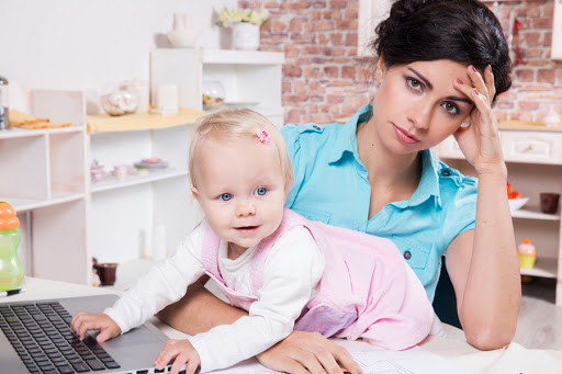 Young business woman with laptop and her baby girl &#8211; fr