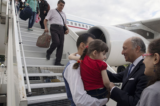 French Foreign Minister Laurent Fabius greets Iraqi Christian refugees upon their arrival in Paris &#8211; fr