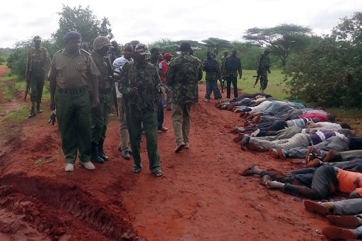 Mandera-Kenya / security forces walking near bodies of victims killed in a dawn attack on a bus
