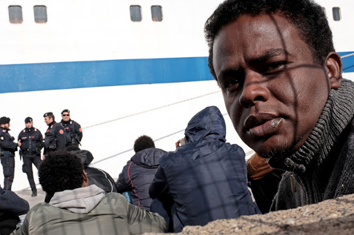 Migrants wait at the port of Lampedusa &#8211; AFP &#8211; fr
