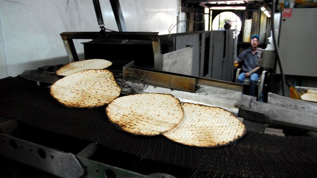 ASHKELON &#8211; APRIL 14: Orthodox Jewish men prepare hand-made glat kosher matzah on April 14 2008 in Ashkelon, Israel.
