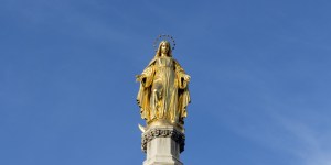 Golden statue of virgin Mary on column