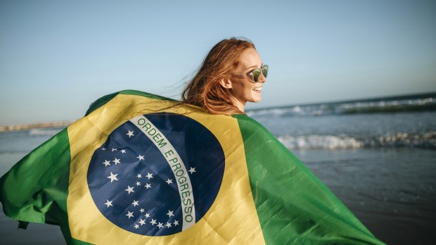 web-girl-smile-flag-brazil-beach-kiko-jimenezshutterstock