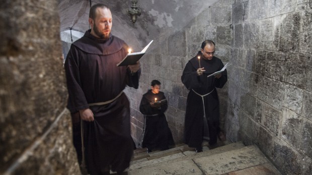 Jerusalem, Israel &#8211; November 26, 2013: Franciscan monks in the Church of Holy Sepulchre during their daily precession. &#8211; shutterstock_571093945
