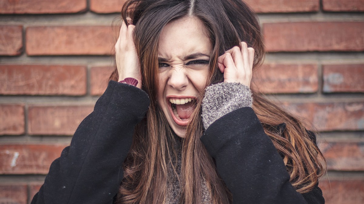 WEB3-WOMAN-BRICK-ANGER-SCREAM-FURIOUS-RAGE-EMOTION-TeodorLazarev-Shutterstock-