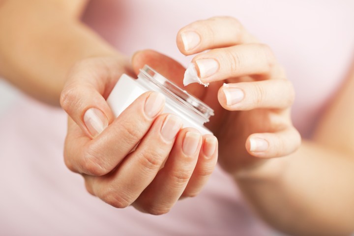 WEB-woman hands applying cream-shutterstock_93555445-Olga Miltsova-AI