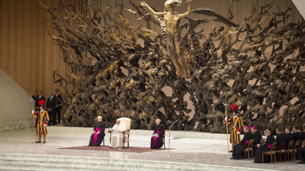 Pope Francis listens on during his weekly general audience