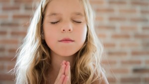 YOUNG GIRL PRAYING