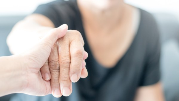 WOMAN HELPING ON OLD ONE