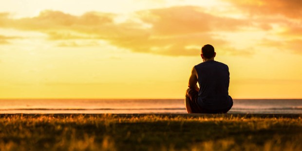 MAN SITTING ALONE