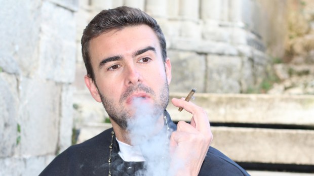 PRIEST SMOKING