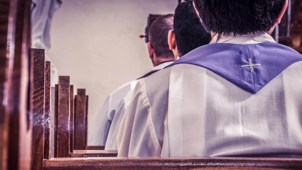 PRIEST IN PEWS