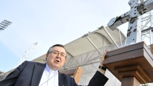 Head of Catholic Church in Bosnia, cardinal Vinko Puljic, stands next to a war damaged cross from one of churches in Bosnia, set up at Sarajevo city stadium, on June 4, 2015. The cross will be displayed during holly mass held by pope Francis during his visit to Bosnia. Pope Francis is to visit Bosnian capital on June 6, bearing messages of peace and reconciliation to nationally devided Bosnia. AFP PHOTO / ELVIS BARUKCIC / AFP PHOTO / ELVIS BARUKCIC