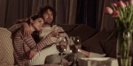 A COUPLE WATCHING TV