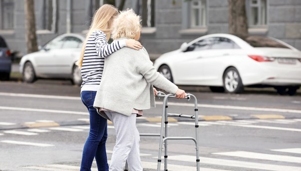 WOMAN HELPING ELDERLY