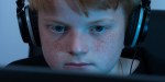 BOY WORKING ON COMPUTER