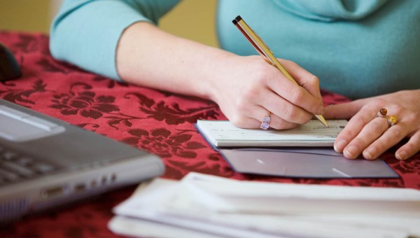 WOMAN,WRITING A CHECK