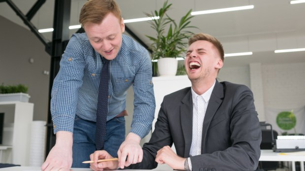 MEN LAUGHING WORK Shutterstock