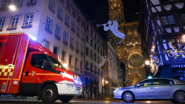 STRASBOURG ATTACKAn emergency medical response vehicle passes by the cathedral in Strasbourg, after a shooting breakout, on December 11, 2018. - A gunman killed at least three people and seriously injured another 11 near the famed Christmas market in the French city of Strasbourg before fleeing the scene, security officials said. Police launched a manhunt after the killer opened fire at around 7pm local time (1800 GMT), sending crowds of evening shoppers fleeing for safety. (Photo by SEBASTIEN BOZON / AFP)