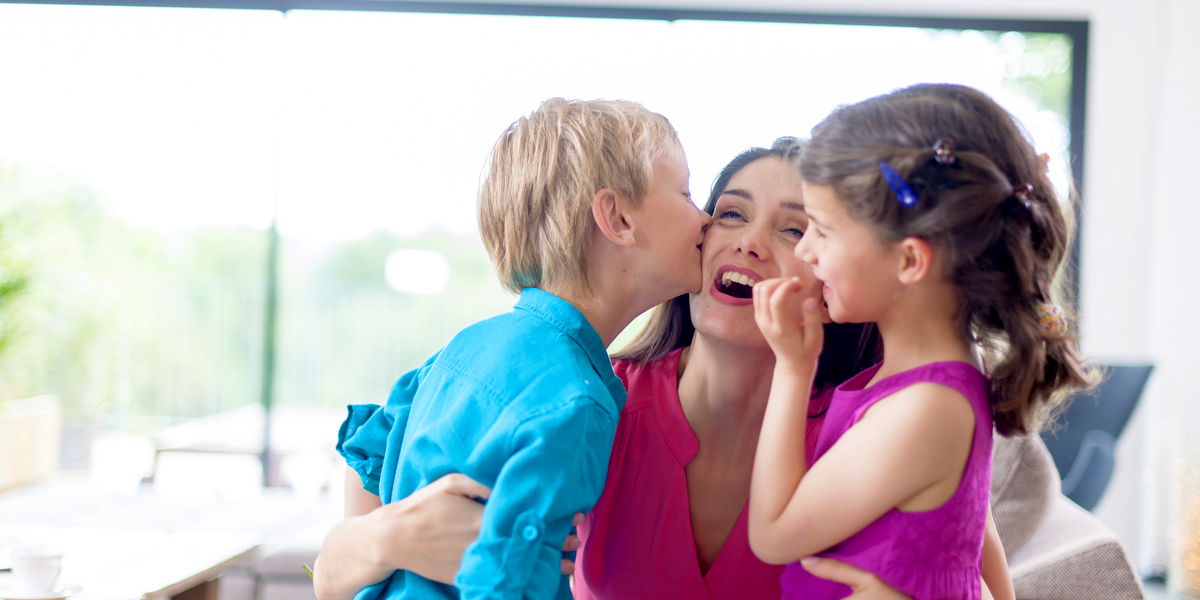 web3-kids-kissing-their-mother-on-a-couch-shutterstock_213498142.jpg