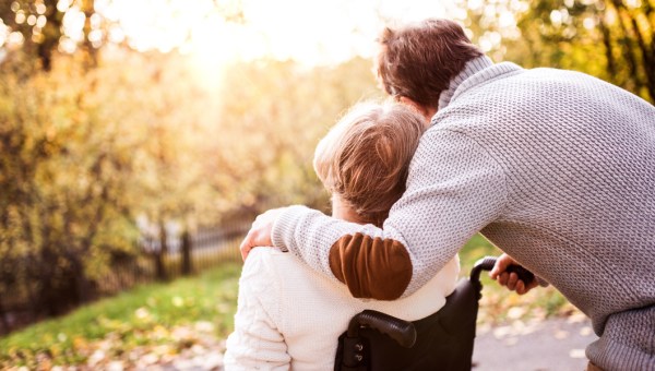 SENIOR COUPLE IN WHEELCHAIR,