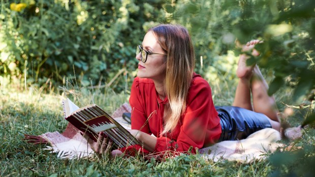 woman book read nature thinking