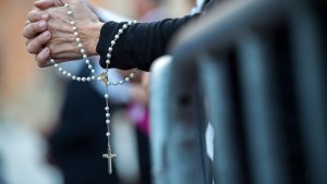Woman Praying the Rosary