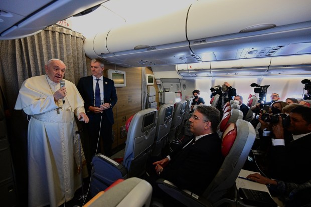 Pope-Francis-addresses-journalists-as-he-boards-a-flight-to-Edmonton-International-Airport-in-Alberta-western-Canad-AFP