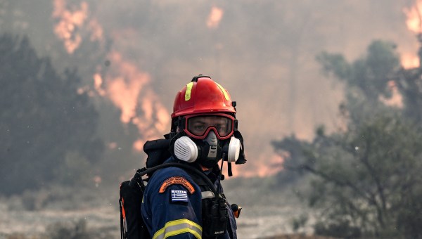 A firefighter looks on during a fire near the village of Vati, just north of the coastal town of Gennadi, in the southern part of the Greek island of Rhodes on July 25, 2023.