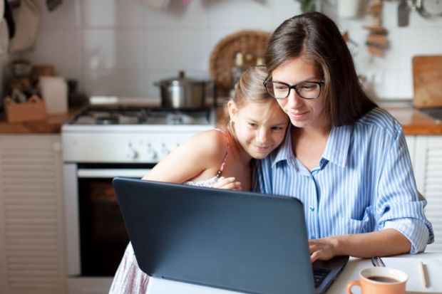 Mother and daughter using laptop