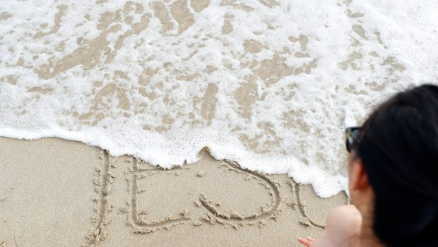 The-word-God-in-the-sand-washed-away-by-the-sea-Vietnam-Godong