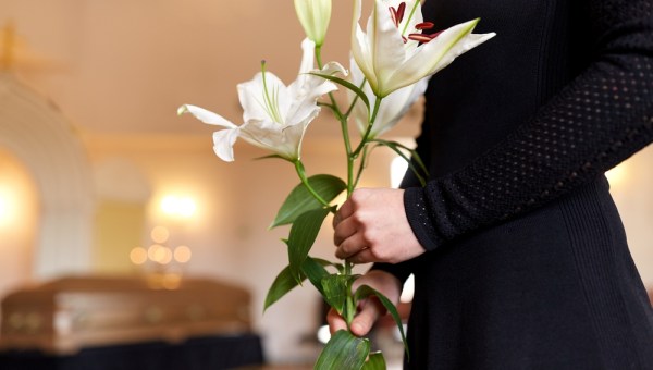 Woman mourning by the coffin