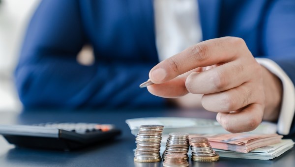 Man counts money with calculator