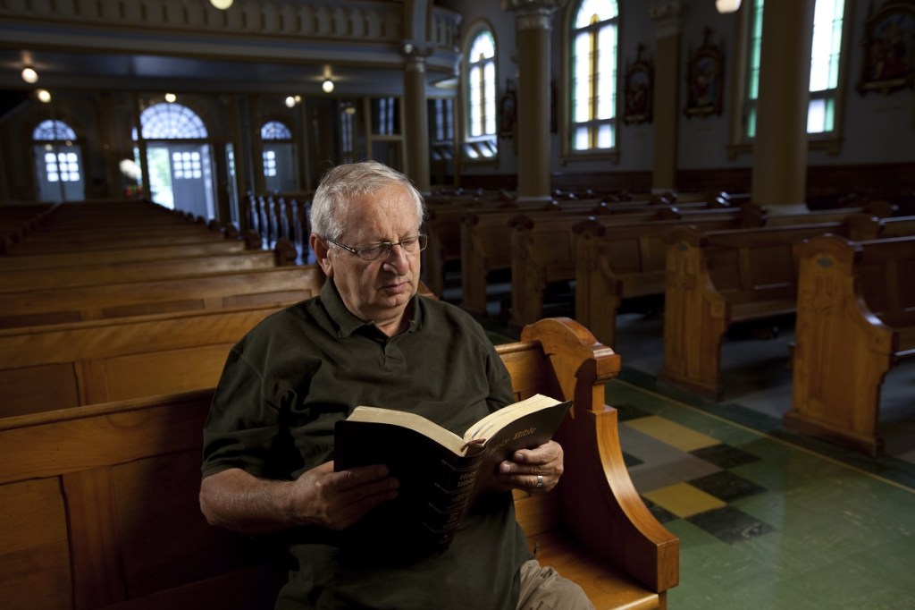 Old man sitting alone in church