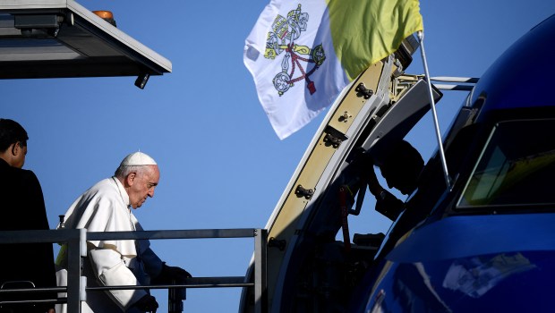 Pope Francis arrives at Rome's Fiumicino airport to board his plane for his trip to Hungary