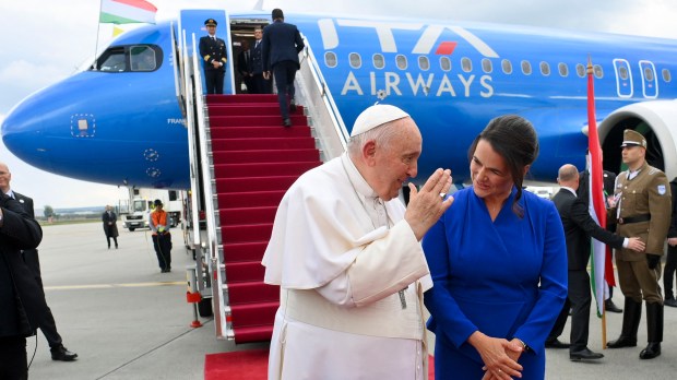 Pope Francis speaks with Hungary's President Katalin Novak during the farewell ceremony at Budapest International Airport