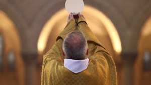 Priest raising Eucharist