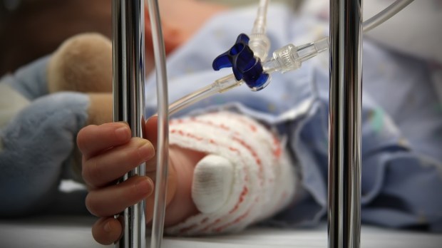 Sick baby in hospital bed