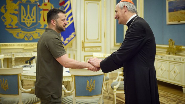 Ukrainian President Volodymyr Zelensky shaking hands with Pope Francis' peace envoy to Ukraine Cardinal Matteo Zuppi