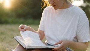 Christian woman holds bible in her hands