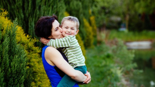 Happy family mother and toddler baby boy with sweet emotion hugging