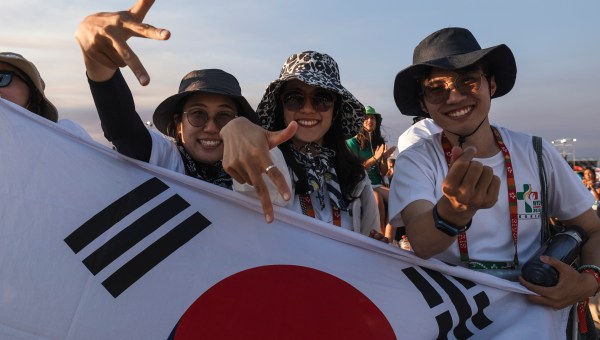 Pilgrims pray during the World Youth Days vigil with young people in Tejo Park, Lisbon