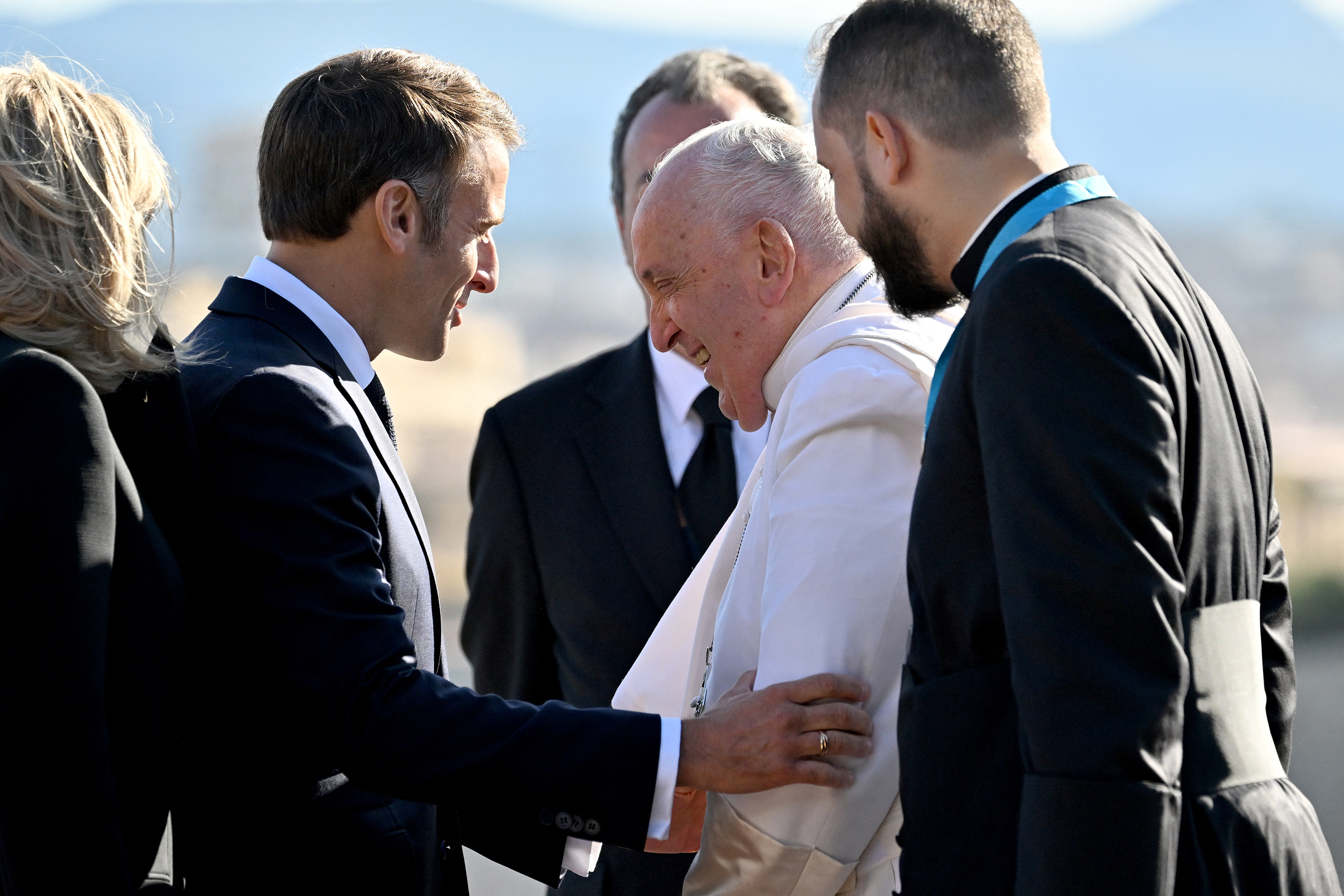 Pope Francis is greeted by French President Emmanuel Macron at the Palais du Pharo in the southern port city of Marseille