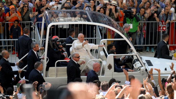 Pope Francis waves as he arrives to celebrate mass at the Velodrome stadium in the southern port city of Marseille