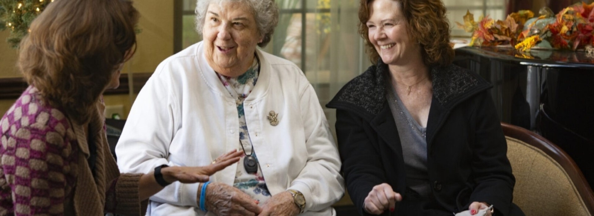 The Rosary Team members praying the rosary with an elder care patient