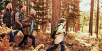 Family hiking in forest in autumn