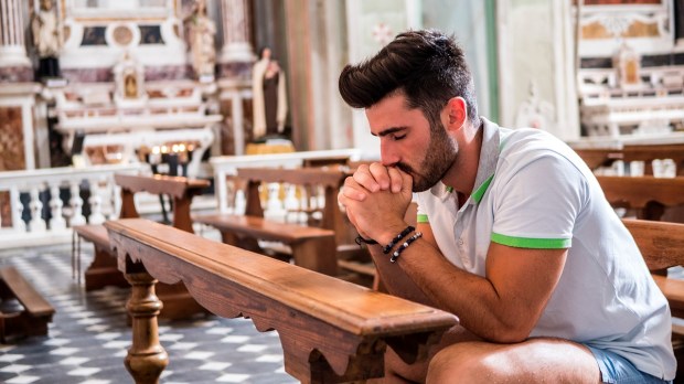 Young adult Catholic in Church