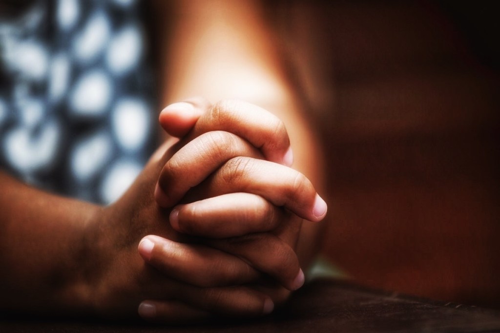Little girl hands folded in prayer