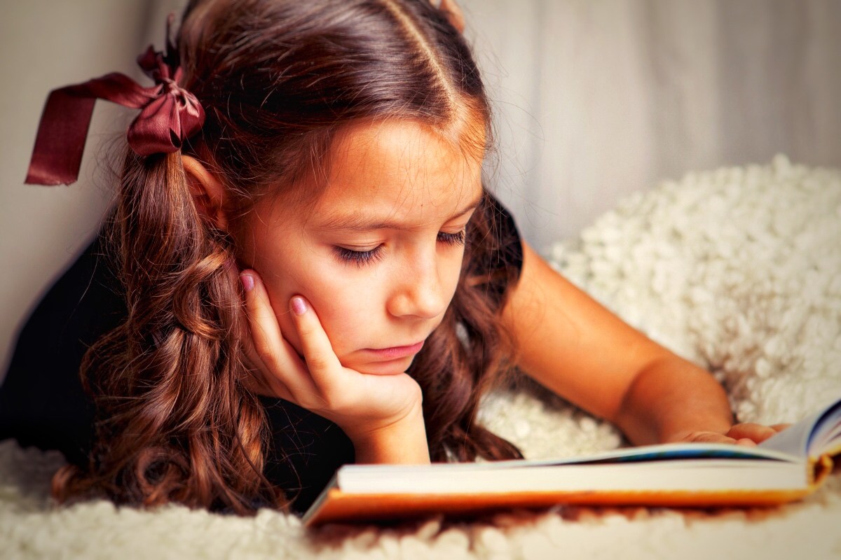 Young girl reading book